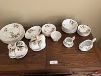 Full arrangement of Ridgway Ironstone Melody Rose 52 piece set including plates, bowls, teacups, saucers, and serving pieces all featuring yellow rose floral pattern.