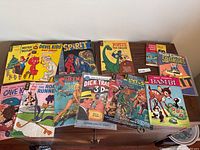 Lot of vintage comics and Disney books arranged on table showing titles and cover art