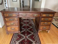 Front view of full double pedestal desk showing seven drawers and central kneehole