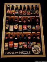 Photo of the completed puzzle image on the box showing rows of beer bottles and caps labeled with vintage beer brands in various colors.