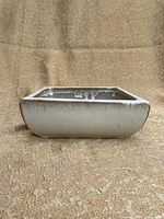 Side view of square glazed ceramic bonsai pot showing its shape, glaze finish, and condition.