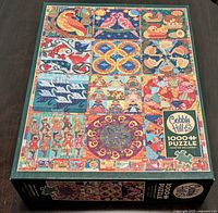 Image of the Cobble Hill puzzle box showing the assembled design from the traditional Christmas song theme with colorful illustrations in a grid pattern.