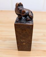 Top-front angled view of the carved animal figure on the stone seal stamp