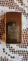 Front view of brass Zippo lighter with the Kingdom of Hawaii coat of arms engraving and '100% brass' marking.