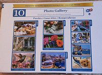 Photo of puzzle box back showing all 10 images included in various piece counts: 200, 300, 500, and 1000 pieces each