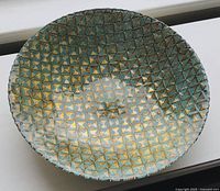 Top-down view showing the bowl's turquoise and gold metallic geometric diamond pattern texture.