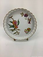 Royal Worcester Evesham dish with scalloped gold trimmed edge and fruit and berry illustrations.
