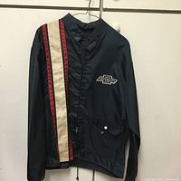 Front view of navy blue Chevrolet jacket with racing stripes and zipper pocket