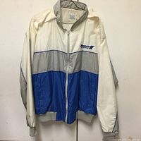 Front view of a color block Michigan Gears jacket in white, gray, and blue, showing zippered front and logo on chest.