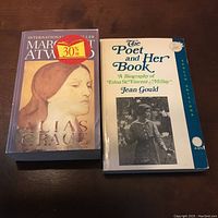 Photo of two paperback books: 'Alias Grace' by Margaret Atwood and 'The Poet and Her Book' biography by Jean Gould.