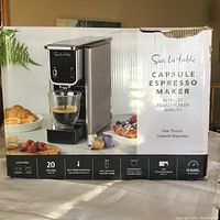 Box of Sur La Table Capsule Espresso Maker showing product image, branding and product features.