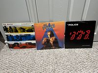 Three Police albums standing upright: Synchronicity, Zenyatta Mondatta, Ghost in the Machine