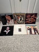 All six Kenny Rogers LP jackets displayed on carpet