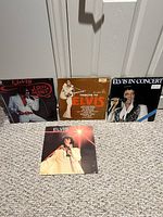 Front view of four Elvis Presley LP jackets displayed on floor