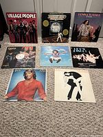 All nine disco era LPs laid out on carpet showing front jackets