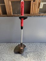 Full view of Craftsman red electric string trimmer upright