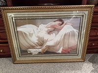 Full view of framed print leaning against dresser