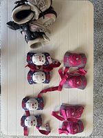 Inline skates, knee pads and elbow pads laid out on table