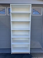 Front view of white IKEA Billy bookcase with five shelves