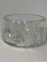 angled view of crystal bowl showing starburst pattern and scalloped rim