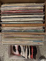 Stack of LP records in box showing spines including Andrés Segovia set