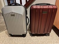 Front view of both suitcases showing color, size and wheel type