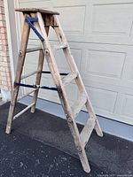 Full view of folded solid wood step ladder