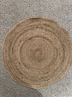 Full view of the round jute mat on carpet