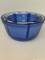 Three cobalt blue glass bowls nested together