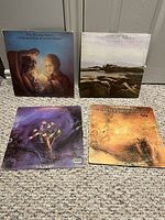 Front view of four Moody Blues LPs arranged on floor showing album covers