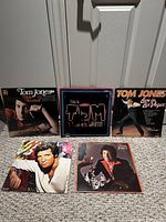 Front covers of all five Tom Jones LPs arranged on floor