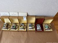 Six Royal Doulton John Beswick limited edition tankards displayed in original boxes, showing detailed relief scenes and numbered markings.