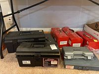 Photo of seven toolboxes of various colors and sizes arranged on floor, each labeled with contents such as electrical connectors, plumbing accessories, phone and cable accessories.