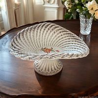 Porcelain lattice pedestal basket bowl on table showing overall shape, floral detail, and condition
