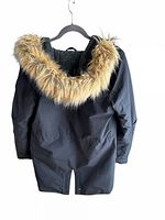 Back view of the black hooded parka with fur trim on the hood, hanging on a hanger.