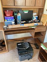 Desk with assortment of office supplies on top and Brother multi-function printer underneath