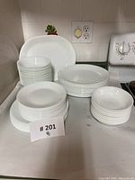 Overview of stacked platters, plates and bowls on kitchen counter
