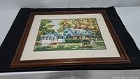 Framed original watercolor painting by Bob Hasle depicting a large house with trees and greenery.
