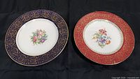 Two Homer Laughlin plated with floral center designs and gold gilded borders.
