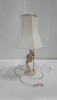 Full view of the three bird lamp with white fabric shade, cord, and plug visible on a plain background.