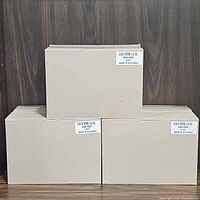 Three cardboard boxes labeled COCO WINE 14 OZ containing wine goblets, stacked on wood surface.