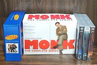 Photo showing Monk: The Complete Series box set, Seinfeld: The Complete Series box set, and multiple season sets of 24 TV series with gray spines.