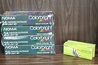 Four boxes stacked showing NOMA Colorbright Jewel One Series indoor/outdoor 25 light sets and two smaller boxes of 45 count miniature Christmas lights.