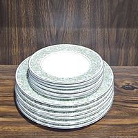 Stack of 12 vintage Royal K Mita Springtime plates showing mostly dinner plates with floral border pattern.