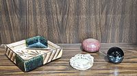 All four items displayed together showing the variety of ceramic and stone items in the lot