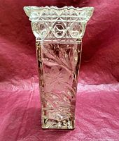 Front view showing floral etched design and scalloped top edge on clear pressed crystal square vase.