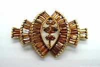 Front view of Keyes brooch showing gold-tone metal and amber baguette and marquise rhinestones, symmetrical Art Deco design.