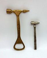 Photo shows the two vintage ice/toffee hammers side by side on a plain background, highlighting the size difference and details.