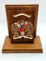 Front view showing wooden base and City of Kingston metal coat of arms plaque