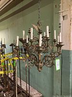 Full front view of chandelier showing all 18 arms, central column, and chain suspension